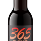 A dark brown glass bottle of beer with a black label featuring the text '365 DAYS OF DARKNESS Barrel Aged Triple Bock' in orange and white lettering, topped with a silver cap, isolated on a white background.