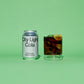 City Light Cola silver grey can and glass with drink on a green background