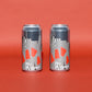 Two aluminum beverage cans with a black, white, and red geometric pattern, standing side-by-side on a solid red background.