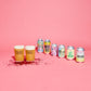 Alcohol cans and glasses on a pink background