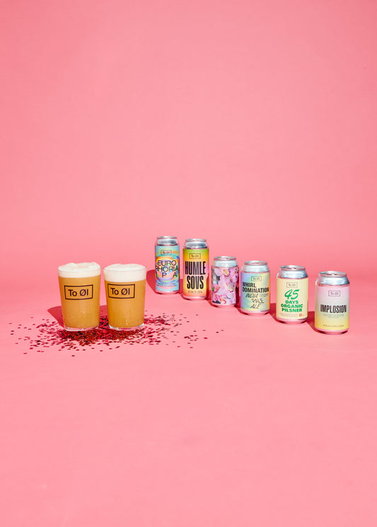 Alcohol cans and glasses on a pink background