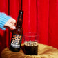 To Øl 365 Days of Darkness poured in a beer glass with red studio background.