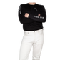 Person wearing BRUS merch: a black long-sleeve shirt with branding and white pants.