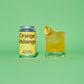 Yellow and silver can of 'Orange Melange' and a glass of orange cocktail on a green background.